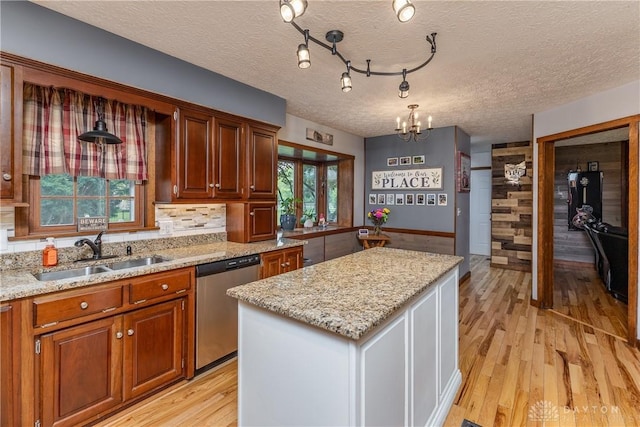 2025 Seneca Dr, Troy, OH 45373 - kitchen featuring dishwasher, a center island, light wood-type flooring, a chandelier, and light stone counters