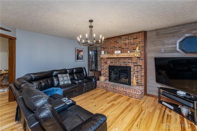 2025 Seneca Dr, Troy, OH 45373 - living area with a chandelier, wood finished floors, a textured ceiling, wood walls, and a fireplace