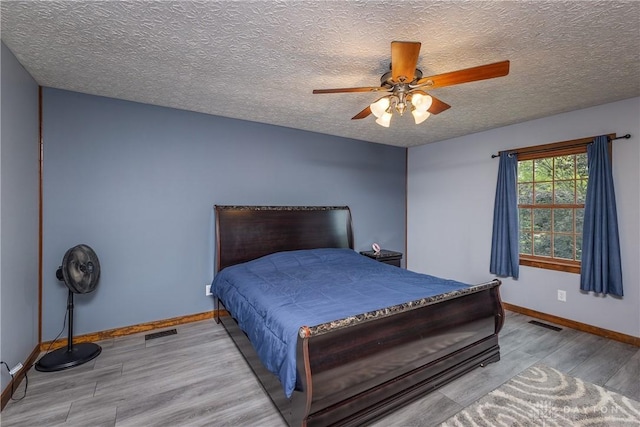 2025 Seneca Dr, Troy, OH 45373 - bedroom with wood finished floors, a textured ceiling, and a ceiling fan