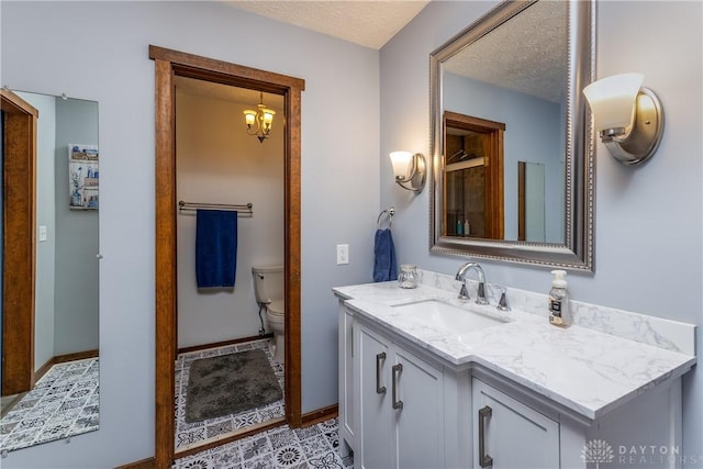 2025 Seneca Dr, Troy, OH 45373 - bathroom featuring vanity, a textured ceiling, and a chandelier