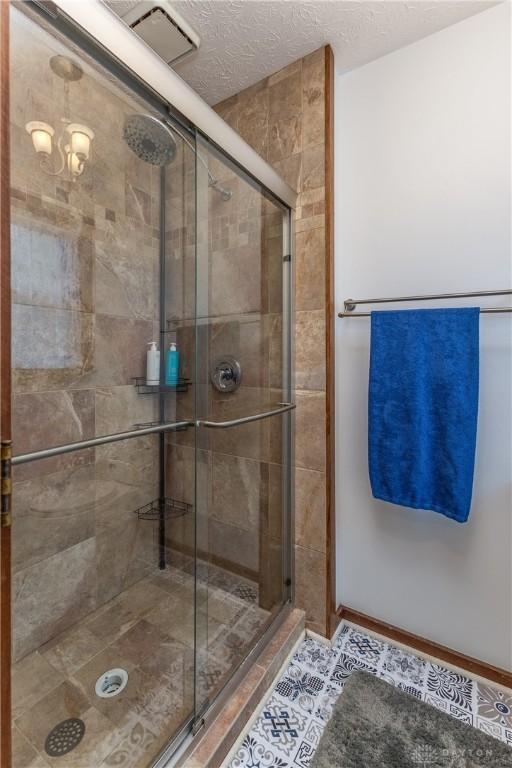 2025 Seneca Dr, Troy, OH 45373 - bathroom with a stall shower and a textured ceiling