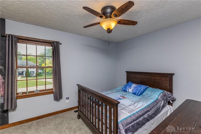 2025 Seneca Dr, Troy, OH 45373 - carpeted bedroom with a textured ceiling and a ceiling fan