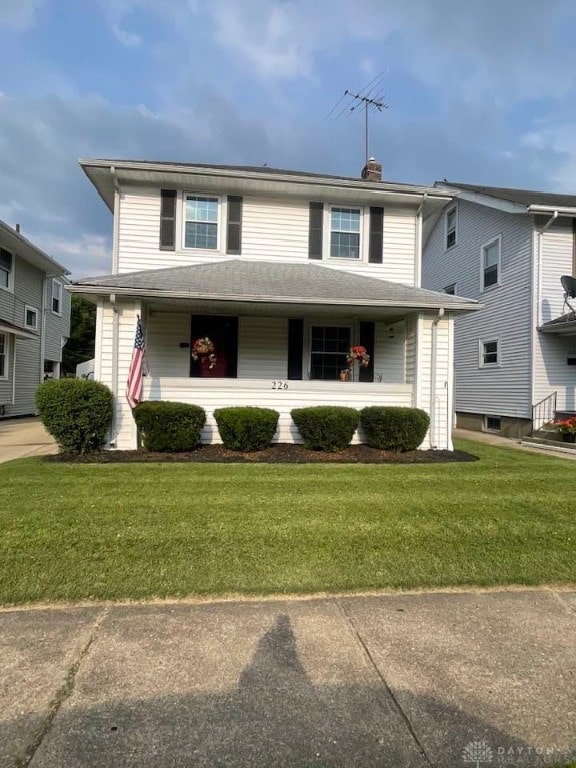 226 Sherman Ave, Hamilton, OH 45013 - view of front of home with covered porch, a front yard, and a chimney