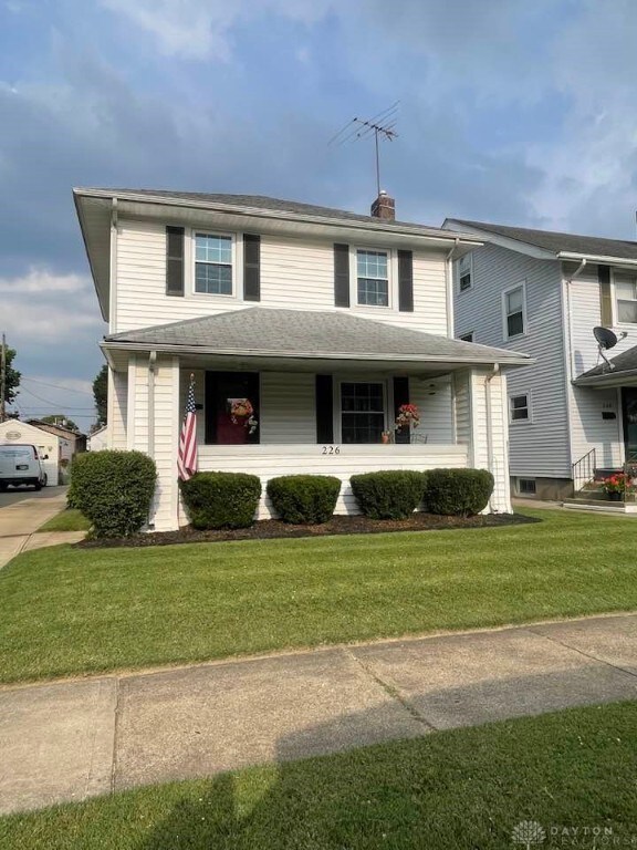 226 Sherman Ave, Hamilton, OH 45013 - view of front of home with a porch, a chimney, and a front lawn