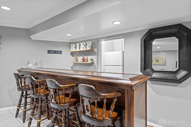 8684 Woodview Dr, Cincinnati, OH 45231 - indoor dry bar featuring freestanding refrigerator, recessed lighting, tile patterned flooring, and crown molding