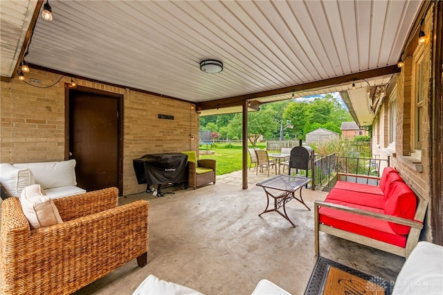 8684 Woodview Dr, Cincinnati, OH 45231 - view of patio featuring outdoor dining space, outdoor lounge area, and a storage unit