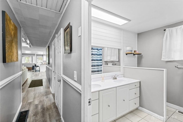 8684 Woodview Dr, Cincinnati, OH 45231 - full bath featuring double vanity and wood finished floors