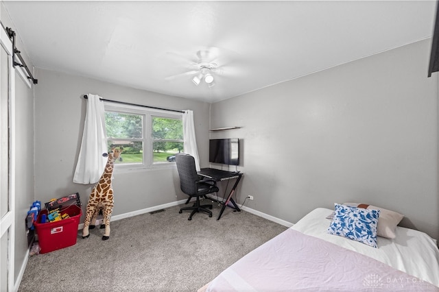8684 Woodview Dr, Cincinnati, OH 45231 - carpeted bedroom with a barn door and ceiling fan