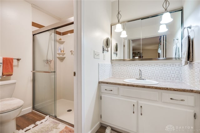 1396 Surrey Rd, Vandalia, OH 45377 - bathroom featuring decorative backsplash, a stall shower, vanity, and wood finished floors