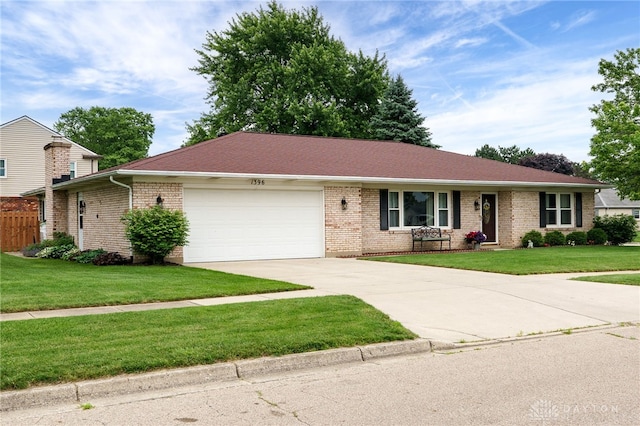 1396 Surrey Rd, Vandalia, OH 45377 - ranch-style house with an attached garage, concrete driveway, brick siding, and a front lawn