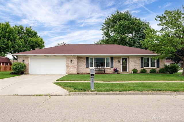 1396 Surrey Rd, Vandalia, OH 45377 - ranch-style home featuring concrete driveway, a garage, a front yard, and brick siding
