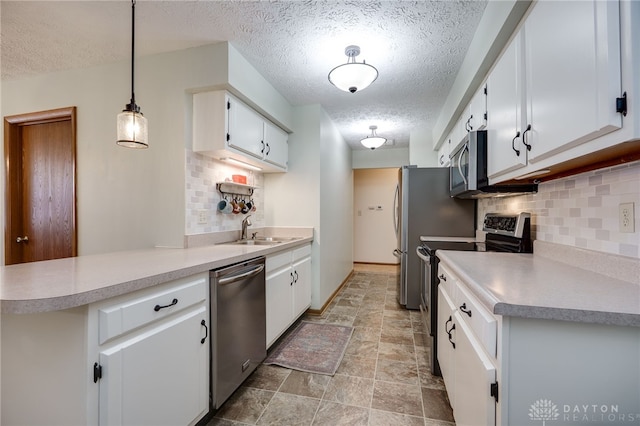 1396 Surrey Rd, Vandalia, OH 45377 - kitchen featuring appliances with stainless steel finishes, backsplash, a textured ceiling, and white cabinets