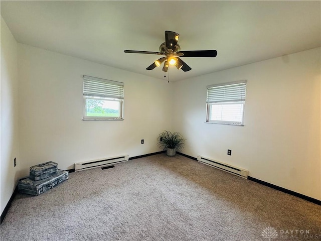 1637 Lammes Ln, New Carlisle, OH 45344 - spare room featuring a baseboard heating unit, plenty of natural light, and carpet flooring