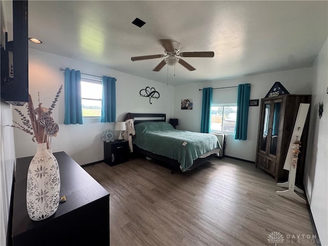 1637 Lammes Ln, New Carlisle, OH 45344 - bedroom featuring multiple windows, wood finished floors, and ceiling fan