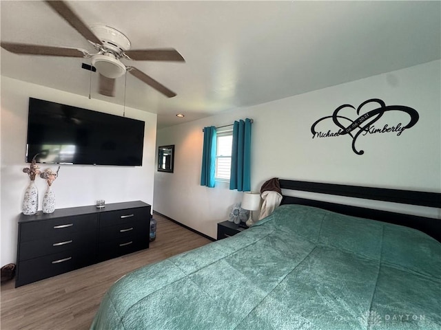 1637 Lammes Ln, New Carlisle, OH 45344 - bedroom with wood finished floors and a ceiling fan