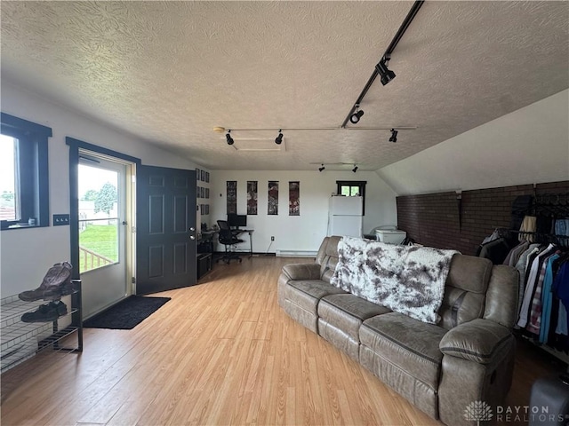 1637 Lammes Ln, New Carlisle, OH 45344 - living room featuring wood finished floors, an office area, rail lighting, and a textured ceiling
