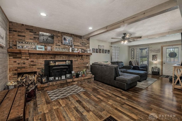 4510 Trenton Franklin Rd, Middletown, OH 45042 - living area with a fireplace, a textured ceiling, wood finished floors, beamed ceiling, and a ceiling fan