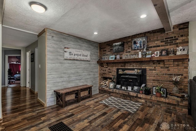 4510 Trenton Franklin Rd, Middletown, OH 45042 - living area featuring a textured ceiling, wood finished floors, a fireplace, wood walls, and recessed lighting