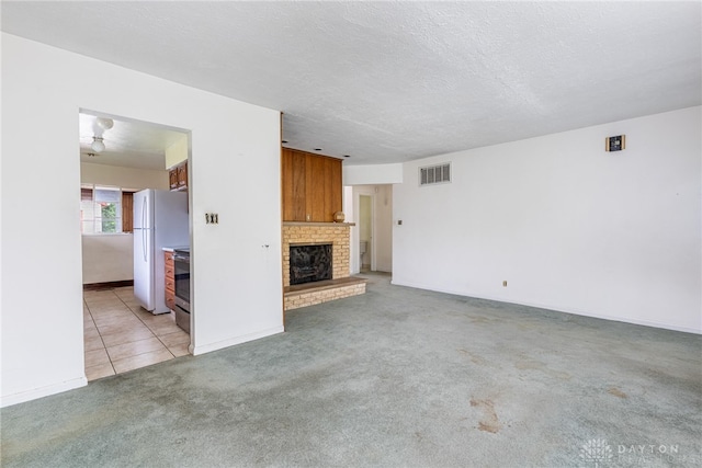 619 Storms Rd, Kettering, OH 45429 - unfurnished living room with light carpet, a fireplace, and light tile patterned floors