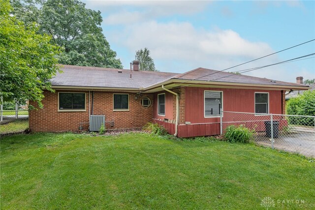 619 Storms Rd, Kettering, OH 45429 - rear view of house with a chimney, brick siding, and a shingled roof
