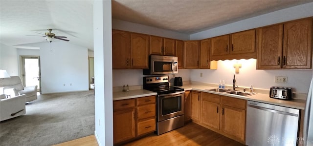 919 N Cherry St, Eaton, OH 45320 - kitchen with appliances with stainless steel finishes, open floor plan, a ceiling fan, light countertops, and brown cabinetry
