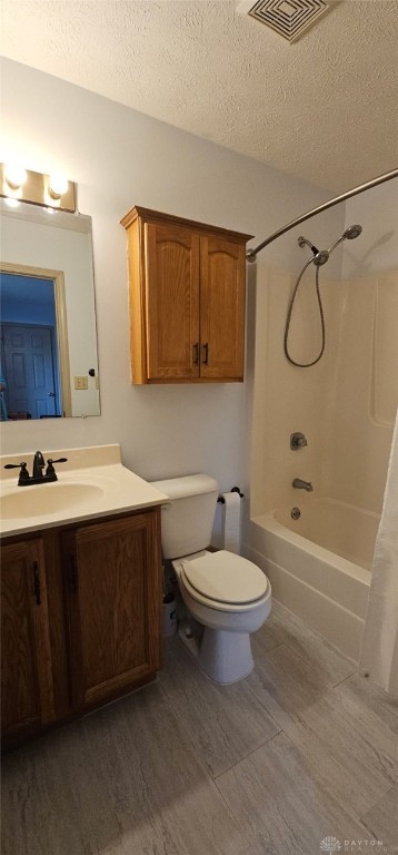 919 N Cherry St, Eaton, OH 45320 - full bath featuring a textured ceiling, wood finished floors, vanity, and shower / bathtub combination