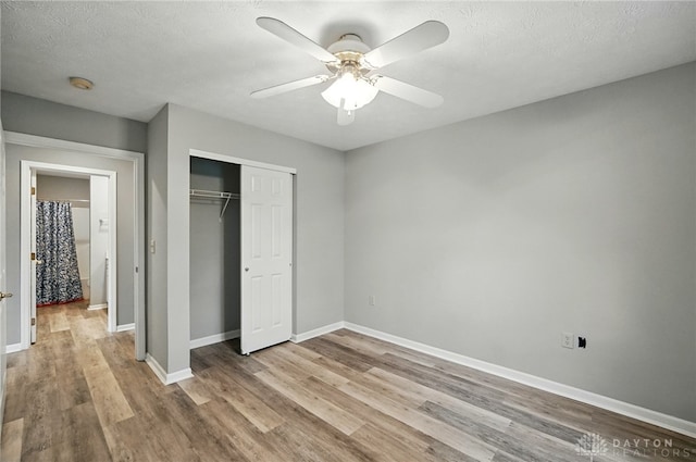 5015 Riverview Ave, Middletown, OH 45042 - unfurnished bedroom featuring wood finished floors, a closet, a ceiling fan, and a textured ceiling