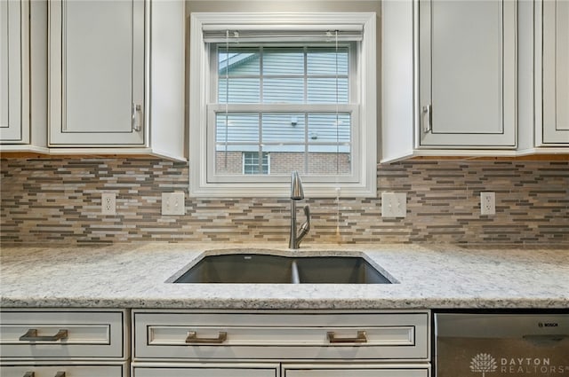 5015 Riverview Ave, Middletown, OH 45042 - kitchen featuring dishwasher, decorative backsplash, light stone counters, and white cabinets