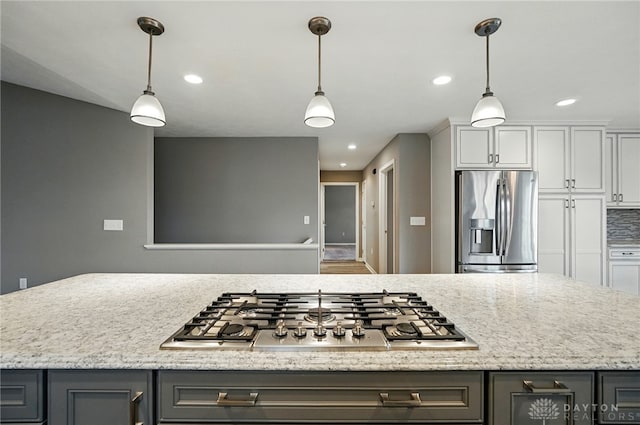 5015 Riverview Ave, Middletown, OH 45042 - kitchen with appliances with stainless steel finishes, gray cabinets, recessed lighting, hanging light fixtures, and light stone countertops