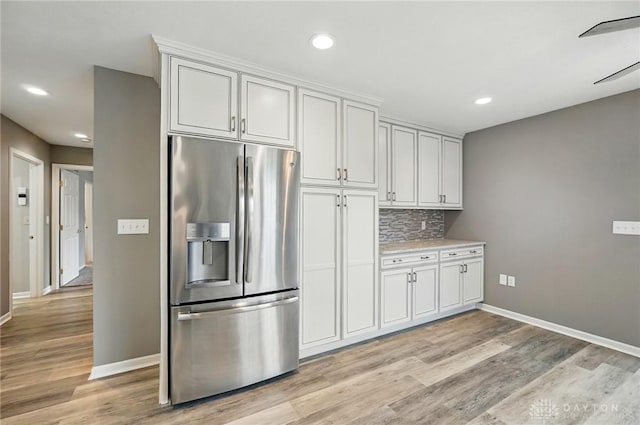 5015 Riverview Ave, Middletown, OH 45042 - kitchen with stainless steel fridge with ice dispenser, light wood-style flooring, recessed lighting, tasteful backsplash, and light countertops