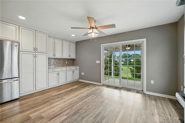 5015 Riverview Ave, Middletown, OH 45042 - kitchen featuring freestanding refrigerator, a ceiling fan, light wood-style floors, tasteful backsplash, and recessed lighting