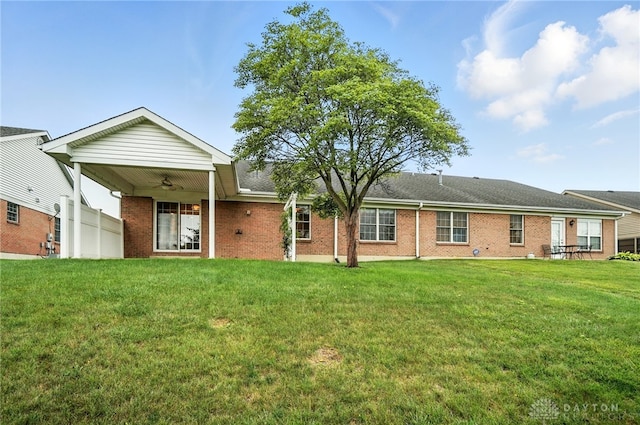 5015 Riverview Ave, Middletown, OH 45042 - back of house with ceiling fan, a yard, and brick siding