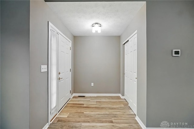 5015 Riverview Ave, Middletown, OH 45042 - foyer entrance featuring light wood finished floors and a textured ceiling