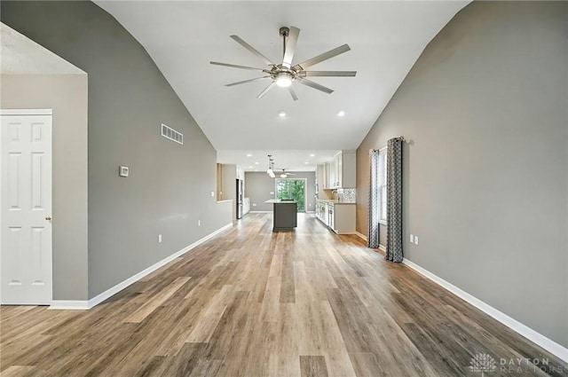 5015 Riverview Ave, Middletown, OH 45042 - unfurnished living room with ceiling fan, high vaulted ceiling, light wood-style floors, and recessed lighting