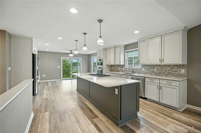 5015 Riverview Ave, Middletown, OH 45042 - kitchen featuring stainless steel appliances, plenty of natural light, backsplash, light wood-type flooring, and recessed lighting