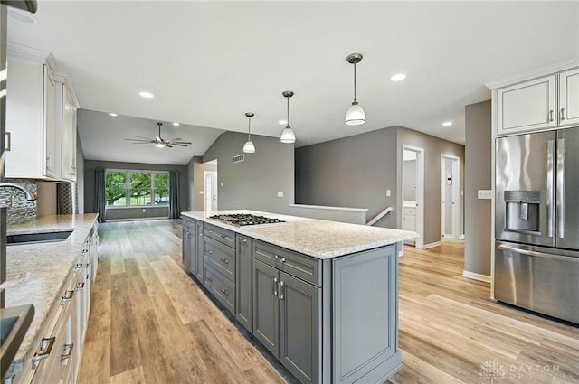 5015 Riverview Ave, Middletown, OH 45042 - kitchen with appliances with stainless steel finishes, gray cabinets, light wood-style flooring, ceiling fan, and a kitchen island
