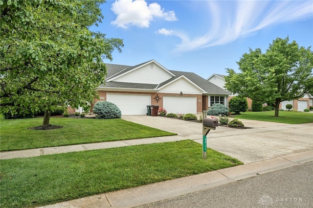 5015 Riverview Ave, Middletown, OH 45042 - traditional-style home featuring concrete driveway, a front yard, an attached garage, and brick siding