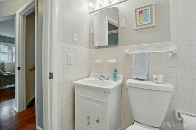 2540 Acorn Dr, Kettering, OH 45419 - bathroom with vanity, wainscoting, tile walls, and wood finished floors