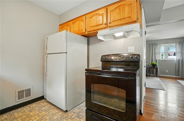 2540 Acorn Dr, Kettering, OH 45419 - kitchen with black electric range, freestanding refrigerator, and under cabinet range hood