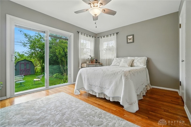 2540 Acorn Dr, Kettering, OH 45419 - bedroom with multiple windows, wood finished floors, access to exterior, and a ceiling fan