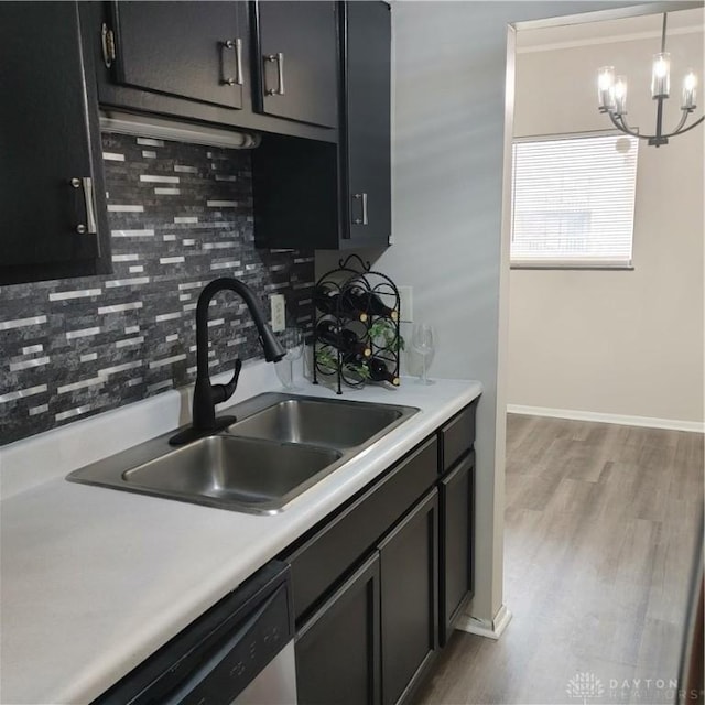 1116 Eagle Feather Cir Unit B, West Carrollton, OH 45449 - kitchen featuring a chandelier, decorative backsplash, stainless steel dishwasher, and light countertops