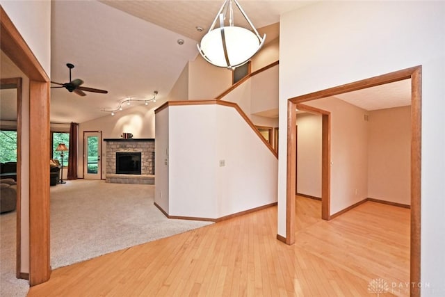 1241 Wind Field Ct, Washington Twp, OH 45458 - unfurnished living room with ceiling fan, hardwood / wood-style flooring, a fireplace, stairs, and lofted ceiling