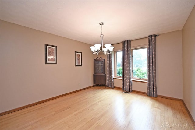 1241 Wind Field Ct, Washington Twp, OH 45458 - empty room featuring a chandelier and light wood-style floors