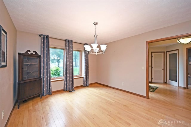 1241 Wind Field Ct, Washington Twp, OH 45458 - spare room featuring a chandelier and light wood finished floors