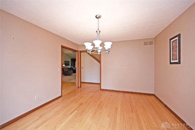 1241 Wind Field Ct, Washington Twp, OH 45458 - spare room featuring a chandelier and light wood-type flooring