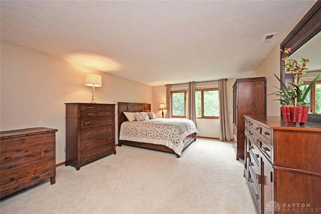 1241 Wind Field Ct, Washington Twp, OH 45458 - bedroom featuring light carpet, multiple windows, and a textured ceiling
