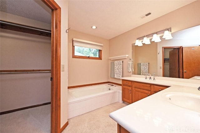 1241 Wind Field Ct, Washington Twp, OH 45458 - full bath featuring double vanity, a bath, a walk in closet, and recessed lighting