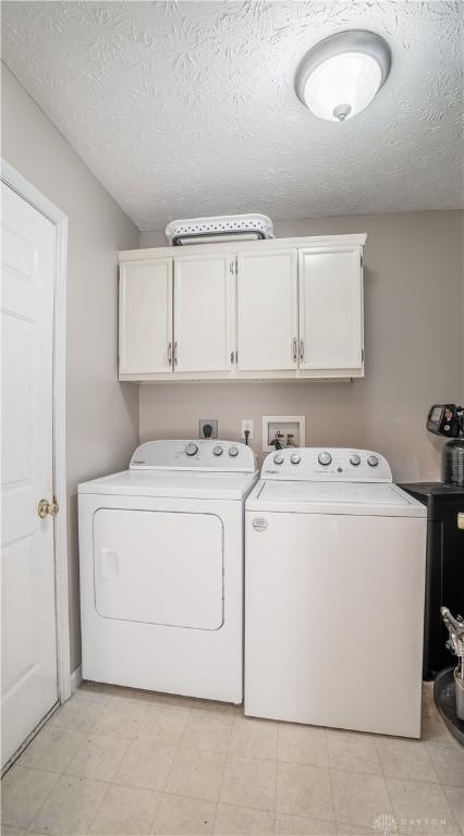 21 Meadowcrest Dr, Franklin, OH 45005 - laundry room with cabinet space, washer and dryer, and a textured ceiling