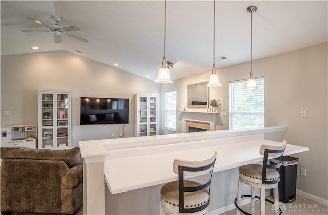 21 Meadowcrest Dr, Franklin, OH 45005 - kitchen featuring ceiling fan, vaulted ceiling, a breakfast bar, open floor plan, and recessed lighting