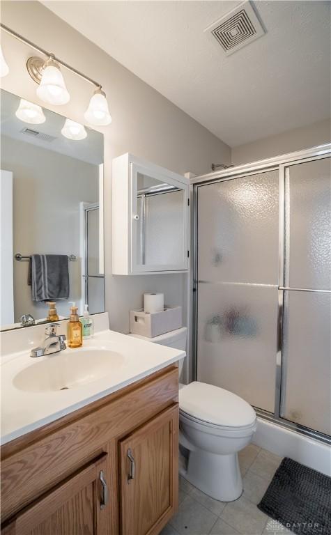 21 Meadowcrest Dr, Franklin, OH 45005 - bathroom featuring vanity, tile patterned floors, and a shower stall